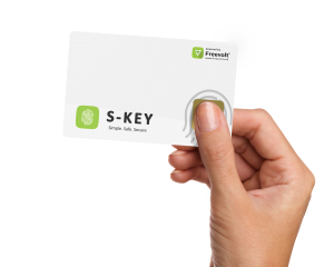 A person holding their thumb on an S-Key smartcard